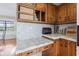Kitchen showcases wood cabinets and tile countertops with ample space and natural light at 241 Melissa Ann Ct, Indianapolis, IN 46234