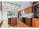 Charming kitchen features a center island, wood cabinets, and views through a large window at 241 Melissa Ann Ct, Indianapolis, IN 46234