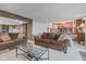 Open-concept living room features cozy sofas, a glass coffee table, and stairway access at 241 Melissa Ann Ct, Indianapolis, IN 46234