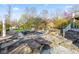 Backyard featuring a patio with lounge chairs, an in-ground pool, and mature trees and landscaping at 241 Melissa Ann Ct, Indianapolis, IN 46234