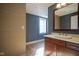 Modern bathroom with custom tiled wall, wood vanity and hardwood floors at 30 W Main St # 3D, Carmel, IN 46032