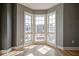 A large bay window with views of the neighborhood provides natural light to this corner room at 30 W Main St # 3D, Carmel, IN 46032