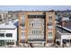 The exterior of a four-story brick building featuring a vintage design and prominent signage at 30 W Main St # 3D, Carmel, IN 46032