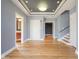Foyer featuring hardwood floors, a view of a powder room and stairs at 30 W Main St # 3D, Carmel, IN 46032