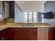 Kitchen featuring granite countertops, wood cabinets, stainless steel appliances, and view to living room at 30 W Main St # 3D, Carmel, IN 46032