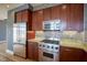 Modern kitchen featuring stainless steel appliances and granite countertops and tiled backsplash at 30 W Main St # 3D, Carmel, IN 46032