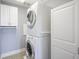 Compact laundry room with a stacked washer and dryer, plus storage cabinets for convenience at 30 W Main St # 3D, Carmel, IN 46032