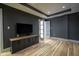 Living room featuring hardwood floors and flat screen television at 30 W Main St # 3D, Carmel, IN 46032