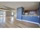Spacious open-concept living area with hardwood floors, blue accent wall, and a glimpse of the kitchen at 30 W Main St # 3D, Carmel, IN 46032