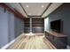 Living room featuring hardwood floors and custom built-in shelving at 30 W Main St # 3D, Carmel, IN 46032