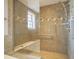 Shower area with tiled walls, a built-in bench, and modern fixtures, providing a luxurious showering experience at 30 W Main St # 3D, Carmel, IN 46032