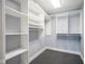 Well-organized walk-in closet with multiple shelves, hanging racks, and ample storage space at 30 W Main St # 3D, Carmel, IN 46032