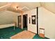 Finished attic space showcasing unique ceiling, carpeting, and compact design at 302 S Sherman Dr, Indianapolis, IN 46201