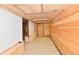 Unfinished basement featuring wooden walls and white brick accents, offering potential for customization at 302 S Sherman Dr, Indianapolis, IN 46201