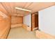 Unfinished basement featuring wooden walls, white brick accents, and bright overhead lighting at 302 S Sherman Dr, Indianapolis, IN 46201