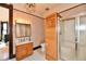 Bathroom with tiled floor, wood shower stall, vanity, and chandelier at 302 S Sherman Dr, Indianapolis, IN 46201