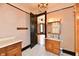 Bathroom featuring tiled floor, wood vanity and shower with chandelier at 302 S Sherman Dr, Indianapolis, IN 46201