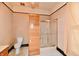 Bathroom features tiled floors, a shower, a toilet, and wood style door at 302 S Sherman Dr, Indianapolis, IN 46201
