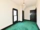 An upstairs bedroom featuring green carpet and lots of natural light from the bright window at 302 S Sherman Dr, Indianapolis, IN 46201