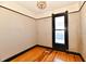 Bright bedroom featuring wood floors, light walls, and dark window trim at 302 S Sherman Dr, Indianapolis, IN 46201