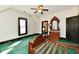 Cozy bedroom featuring vintage furniture, patterned wallpaper, and a ceiling fan at 302 S Sherman Dr, Indianapolis, IN 46201