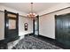 Dining room featuring chandelier, ornate area rug, and dark wood trim at 302 S Sherman Dr, Indianapolis, IN 46201
