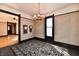 Dining room featuring chandelier, hardwood floors, and vintage charm at 302 S Sherman Dr, Indianapolis, IN 46201