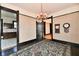 Dining room featuring chandelier, hardwood floors, and dark wood trim at 302 S Sherman Dr, Indianapolis, IN 46201