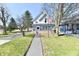Charming two-story home with an American flag displayed out front and inviting front porch at 302 S Sherman Dr, Indianapolis, IN 46201