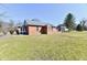 Side view of a brick building with stained glass windows and an expansive lawn at 302 S Sherman Dr, Indianapolis, IN 46201