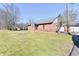 Beautiful brick building featuring a green lawn, blue skies, and symmetrical design at 302 S Sherman Dr, Indianapolis, IN 46201