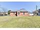 Brick building featuring stained glass window with a well-manicured lawn at 302 S Sherman Dr, Indianapolis, IN 46201