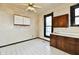 Kitchen featuring tile floor, wood cabinets, and a ceiling fan at 302 S Sherman Dr, Indianapolis, IN 46201