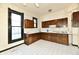 This kitchen has white tile floors, dark-wood cabinets, and lots of natural light at 302 S Sherman Dr, Indianapolis, IN 46201