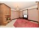 Bright room features a unique fireplace, pink carpet, marble floors and classic chandelier at 302 S Sherman Dr, Indianapolis, IN 46201