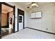 Bright living room with white tile floors, white cabinetry, and black-trimmed doors and windows at 302 S Sherman Dr, Indianapolis, IN 46201