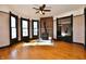 Spacious living room with wood floors, wood-burning stove, and large windows at 302 S Sherman Dr, Indianapolis, IN 46201
