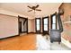 Living room with wood-burning stove, wood floors, and ceiling fan at 302 S Sherman Dr, Indianapolis, IN 46201