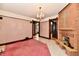 Spacious living room features marble floors, pink carpet, a fireplace and chandelier lighting at 302 S Sherman Dr, Indianapolis, IN 46201