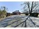 Paved parking lot, lined with trees, leading to the brick building at 302 S Sherman Dr, Indianapolis, IN 46201