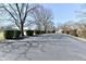 Cracked parking lot with mature trees in a suburban setting at 302 S Sherman Dr, Indianapolis, IN 46201