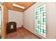Corner room featuring decorative glass block window, wainscotting, and a crib at 302 S Sherman Dr, Indianapolis, IN 46201