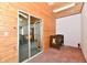 Hallway featuring a door with a glass inset, wood wainscotting, and a crib at 302 S Sherman Dr, Indianapolis, IN 46201