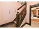 The stairway features a wooden banister, carpeted stairs, and a hanging chandelier at 302 S Sherman Dr, Indianapolis, IN 46201