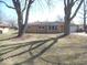 Charming single-story home with a brick facade and mature trees in the front yard at 32 S Elma St, Anderson, IN 46012