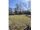 Spacious backyard featuring a green lawn, some trees, and a wooden deck perfect for outdoor activities at 3531 Welch Dr, Indianapolis, IN 46224