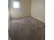 Neutral bedroom with a door leading to the backyard, offering functional living space at 3531 Welch Dr, Indianapolis, IN 46224