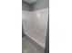 White tub-shower combo in a bathroom with blue walls at 3550 N Edmondson Ave, Indianapolis, IN 46226