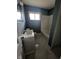 Bathroom features a white vanity, toilet, and tub-shower combo with blue walls at 3550 N Edmondson Ave, Indianapolis, IN 46226