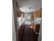 A kitchen featuring wood cabinets, marble countertops, and dark wood flooring at 3550 N Edmondson Ave, Indianapolis, IN 46226